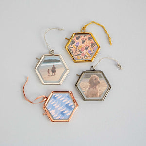 These stylish hexagonal photo frames are handmade from recycled glass and metal.
With a hinged opening, they’re easy to fill with photos, pressed flowers and keepsakes.

