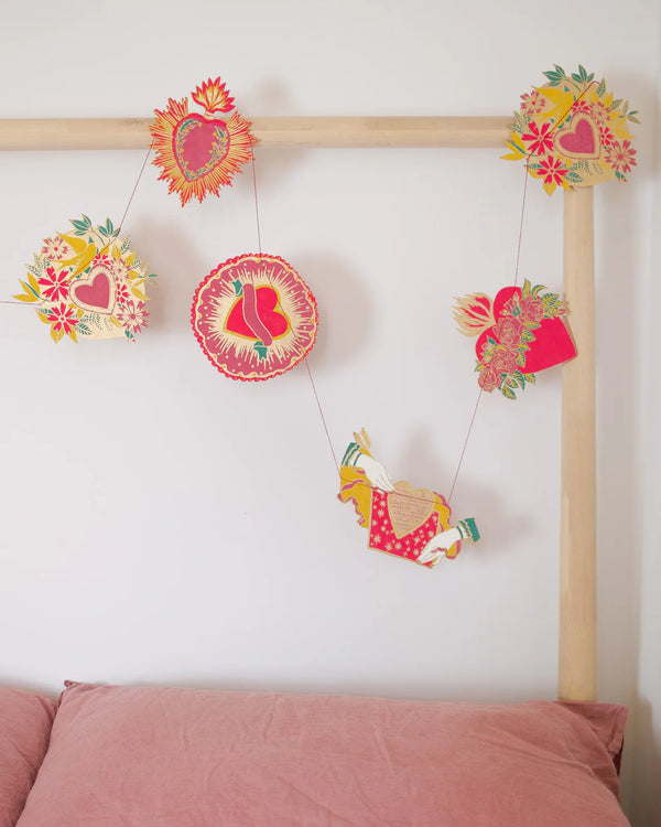 East End Press hearts valentine garland hanging above a modern bed